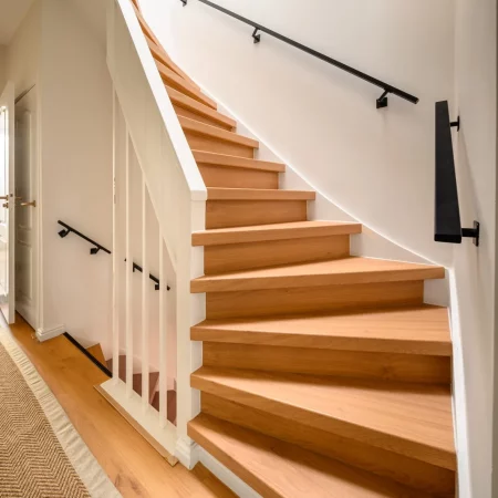 Trap met houten treden en witte balustrade na renovatie, Schiedam