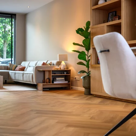Woonkamer met visgraatvloer en werkplek na renovatie, Schiedam